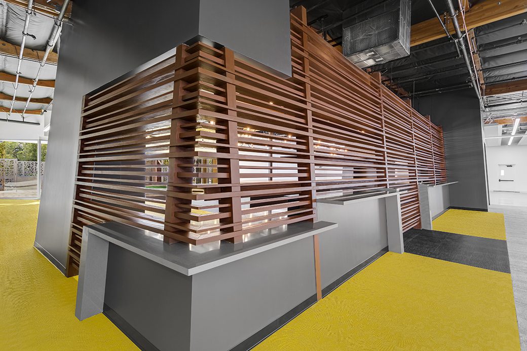 Interior wood slat divider over yellow flooring